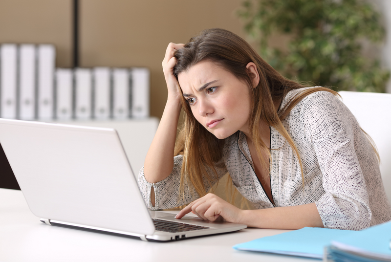 Woman overwhelmed by the LSAT's difficulty staring at a laptop screen while studying.