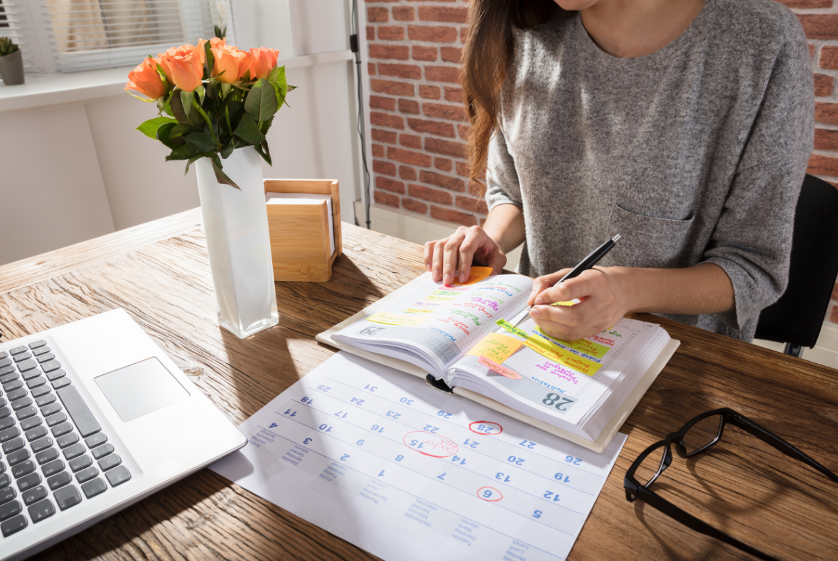 woman planning out her GRE practice test schedule to prepare for the exam