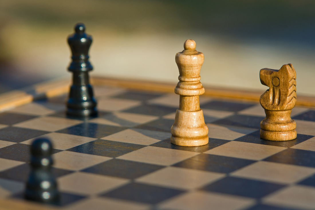 Photo of a chess game in progress with four pieces on the board.
