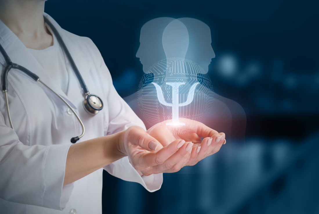 Female doctor with cupped hands holding a hologram of the symbol for psychology.